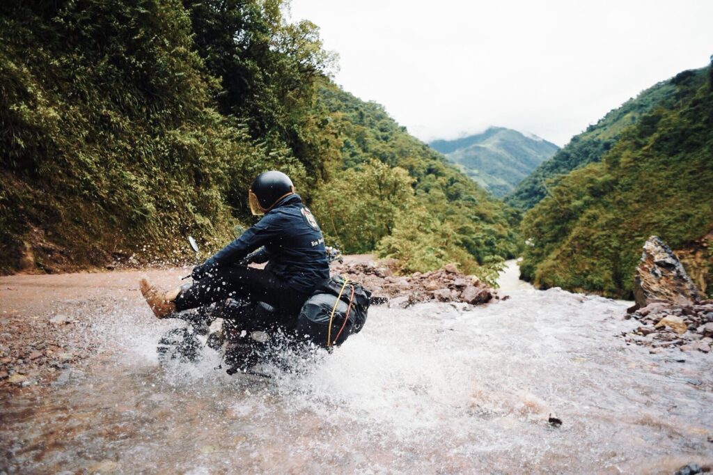 Monkey Bike crossing a stream in the Andes Mountains - Monkey Run Peru