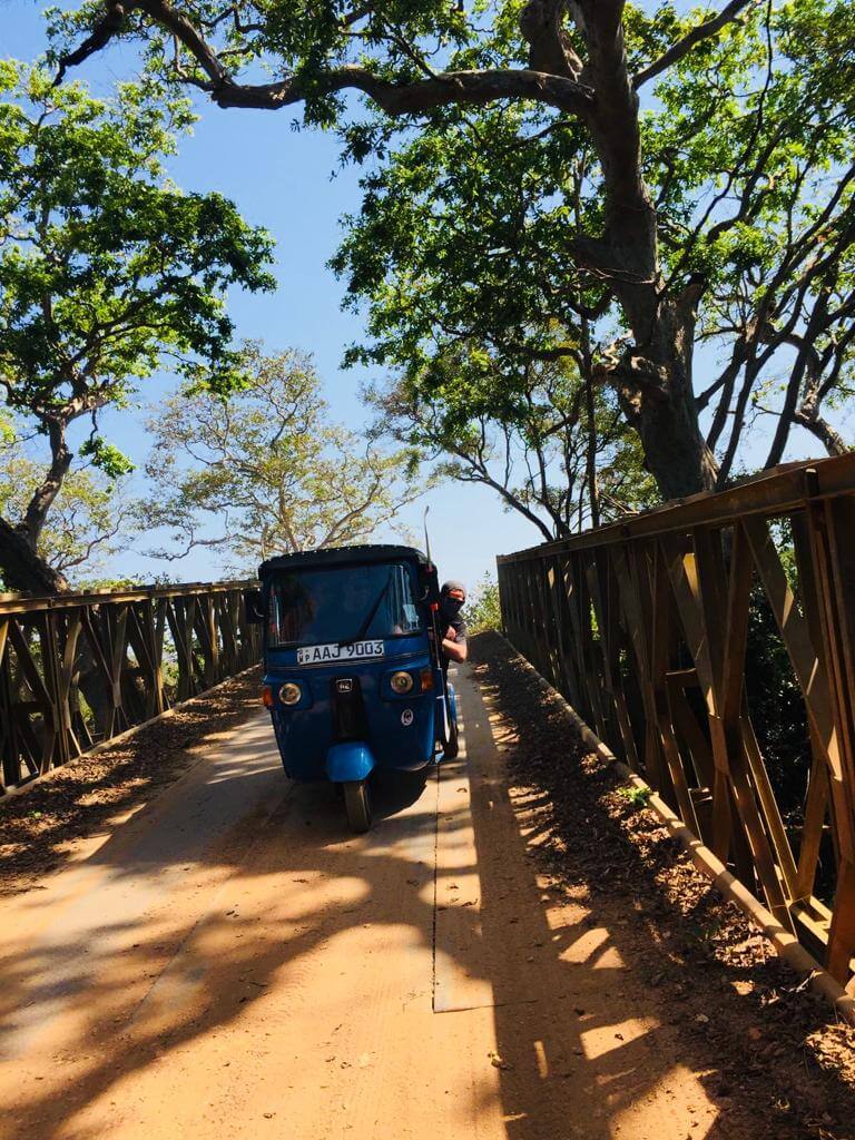 Rickshaw driving over a bridge